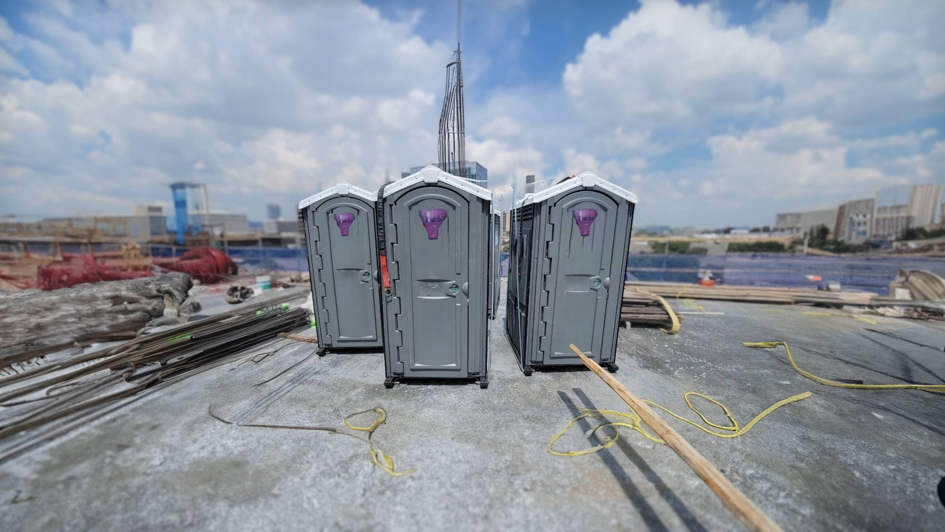 Portable toilets being delivered to a building site